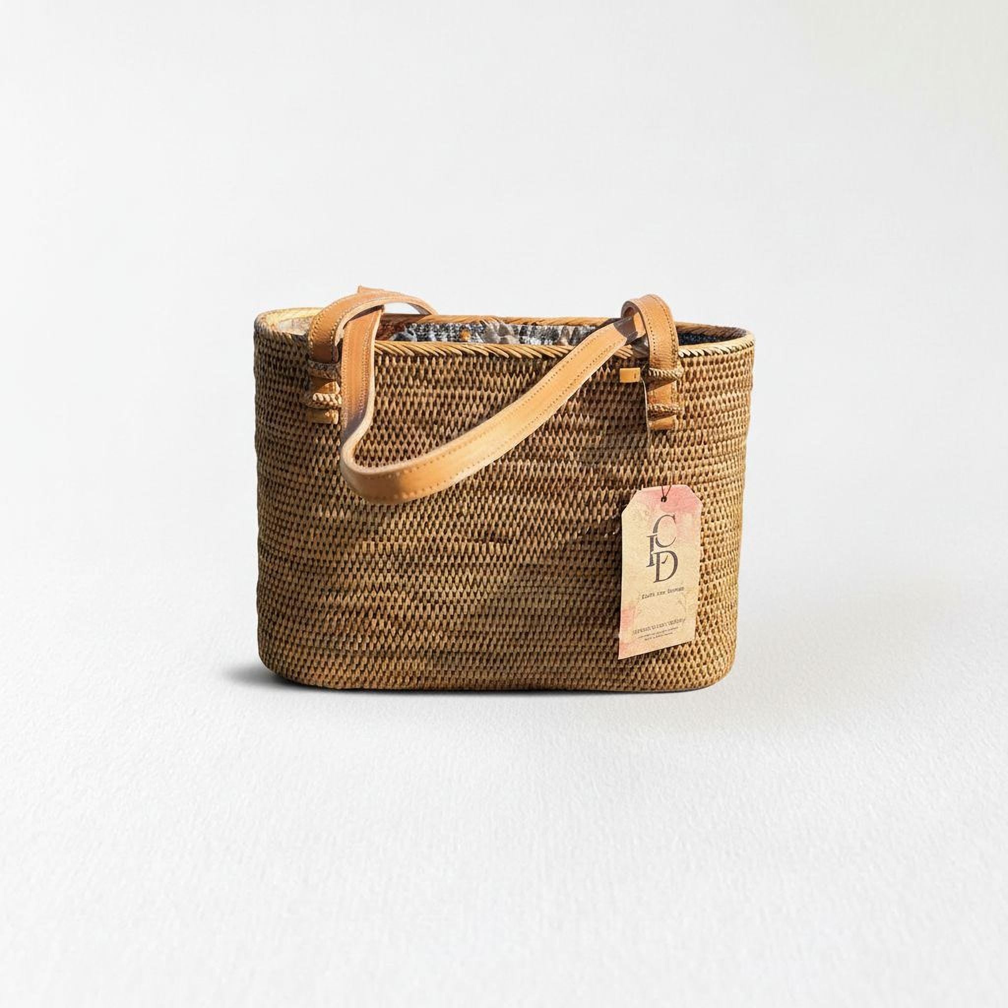 A brown woven handbag with a leather strap and a tag attached to it.