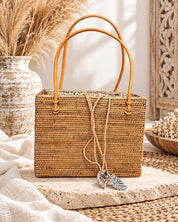 Rattan square tote with batik liner styled on a boho table with dried pampas grass
