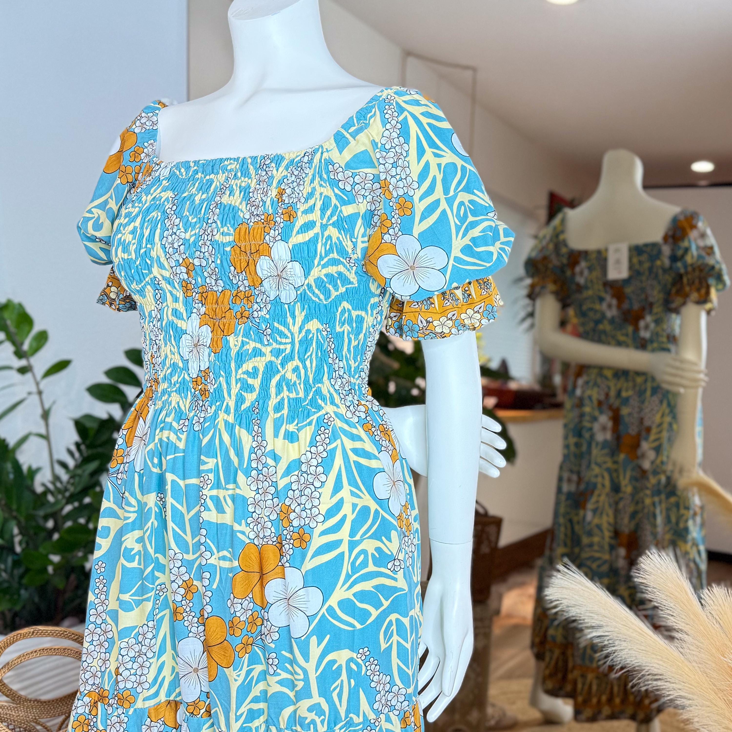 A mannequin wearing a blue and yellow floral print dress with a ruffled neckline and puffed sleeves, displayed in a clothing store.