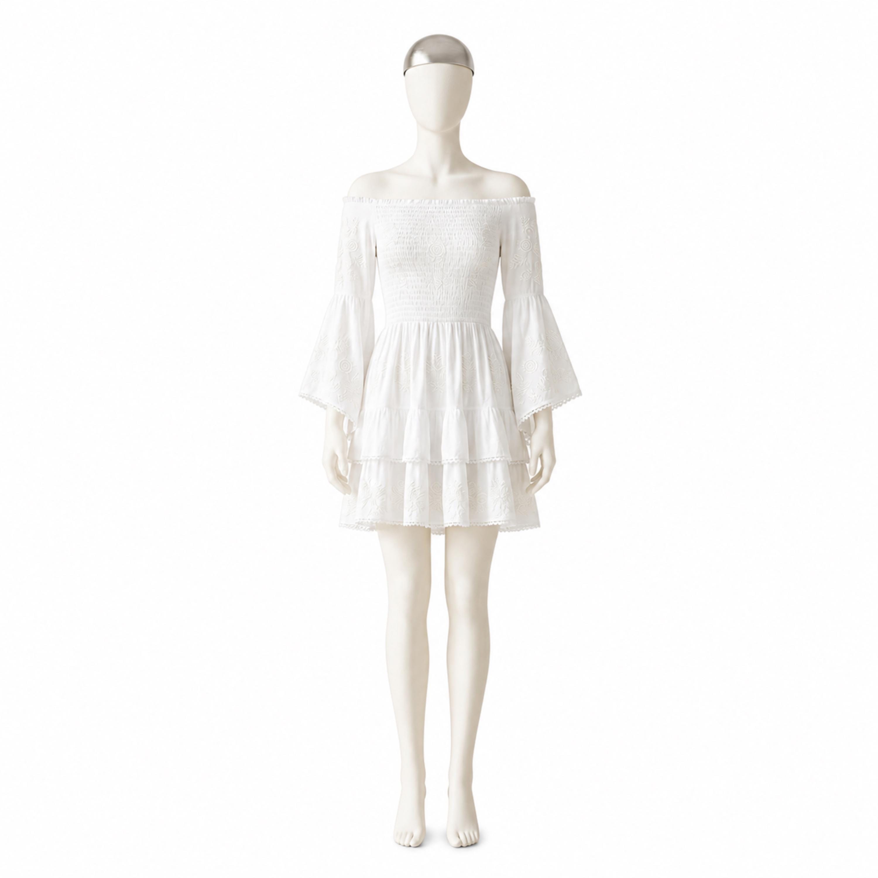 A mannequin wearing a white off-the-shoulder dress with bell sleeves and a ruffled skirt.