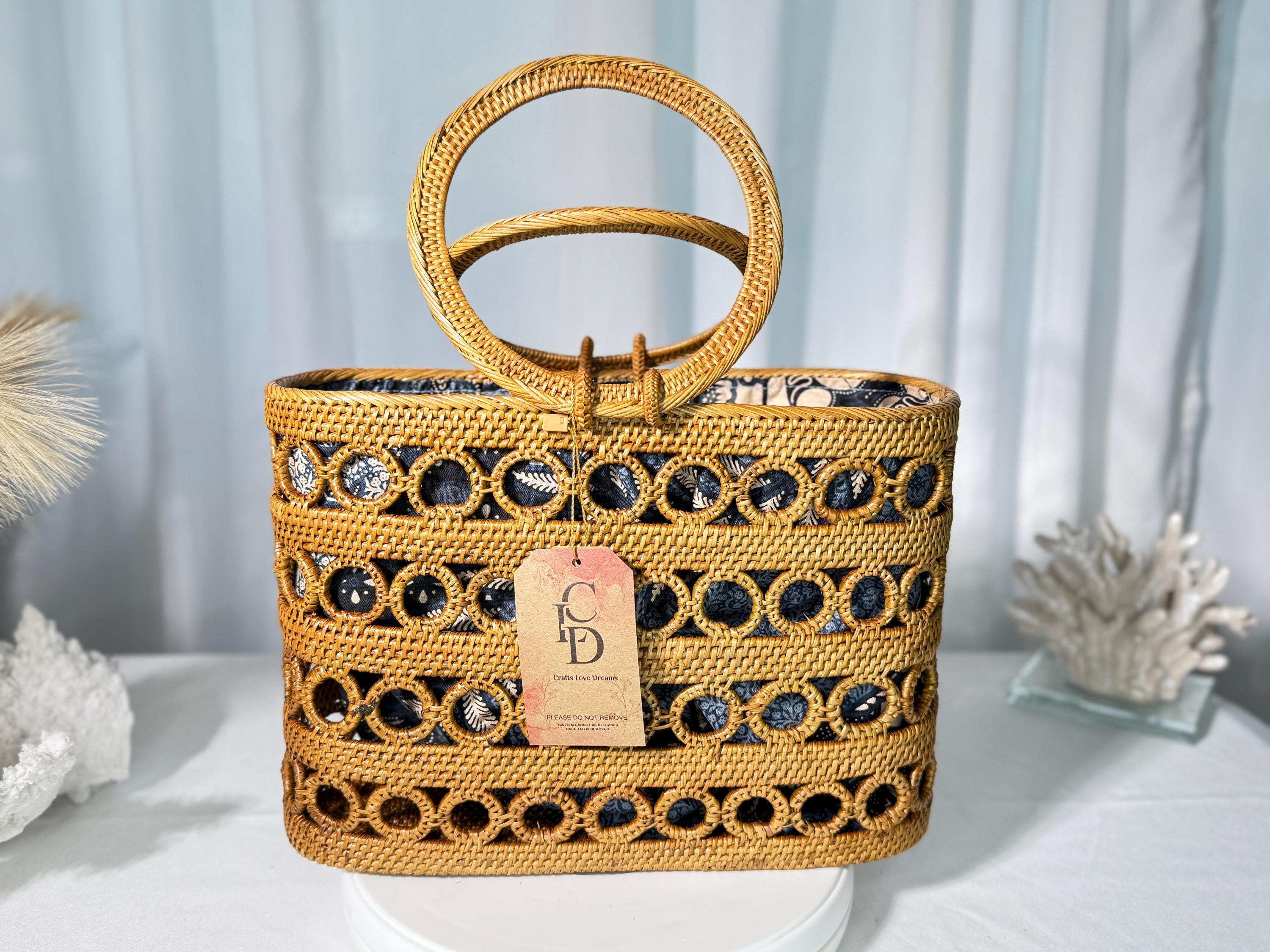 A woven handbag with a round handle and a tag displaying the letters 'CID' is displayed on a white surface.