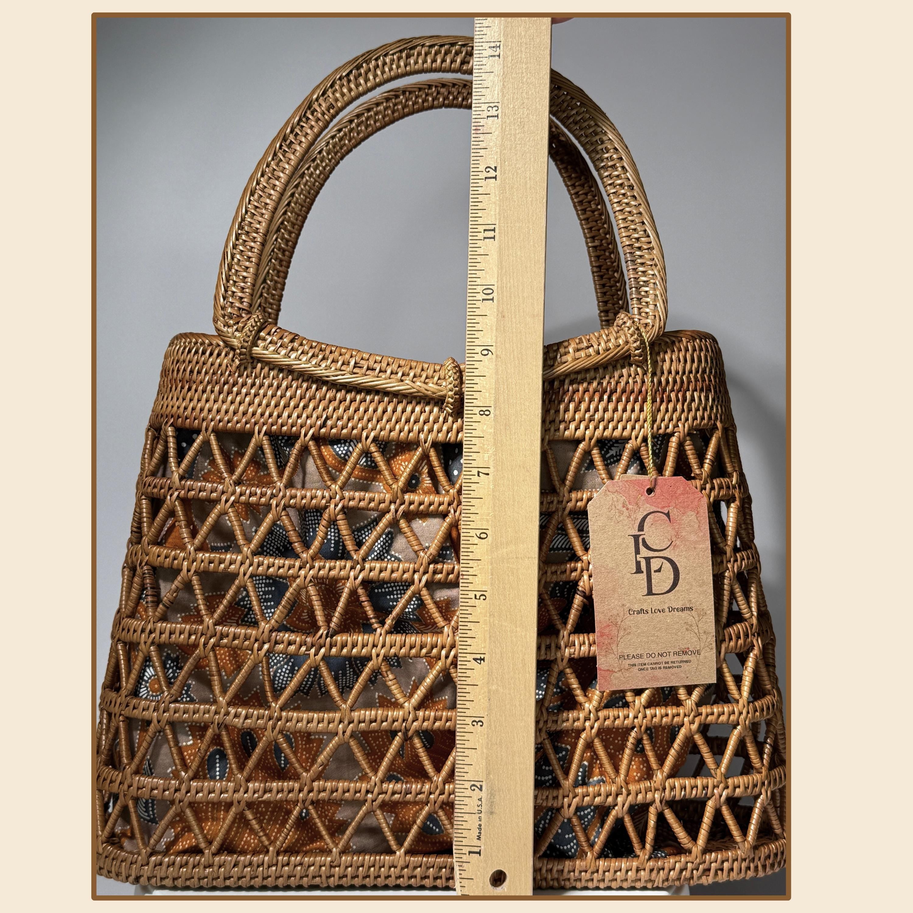 A woven handbag with a handle and a ruler placed next to it, indicating the size of the bag.