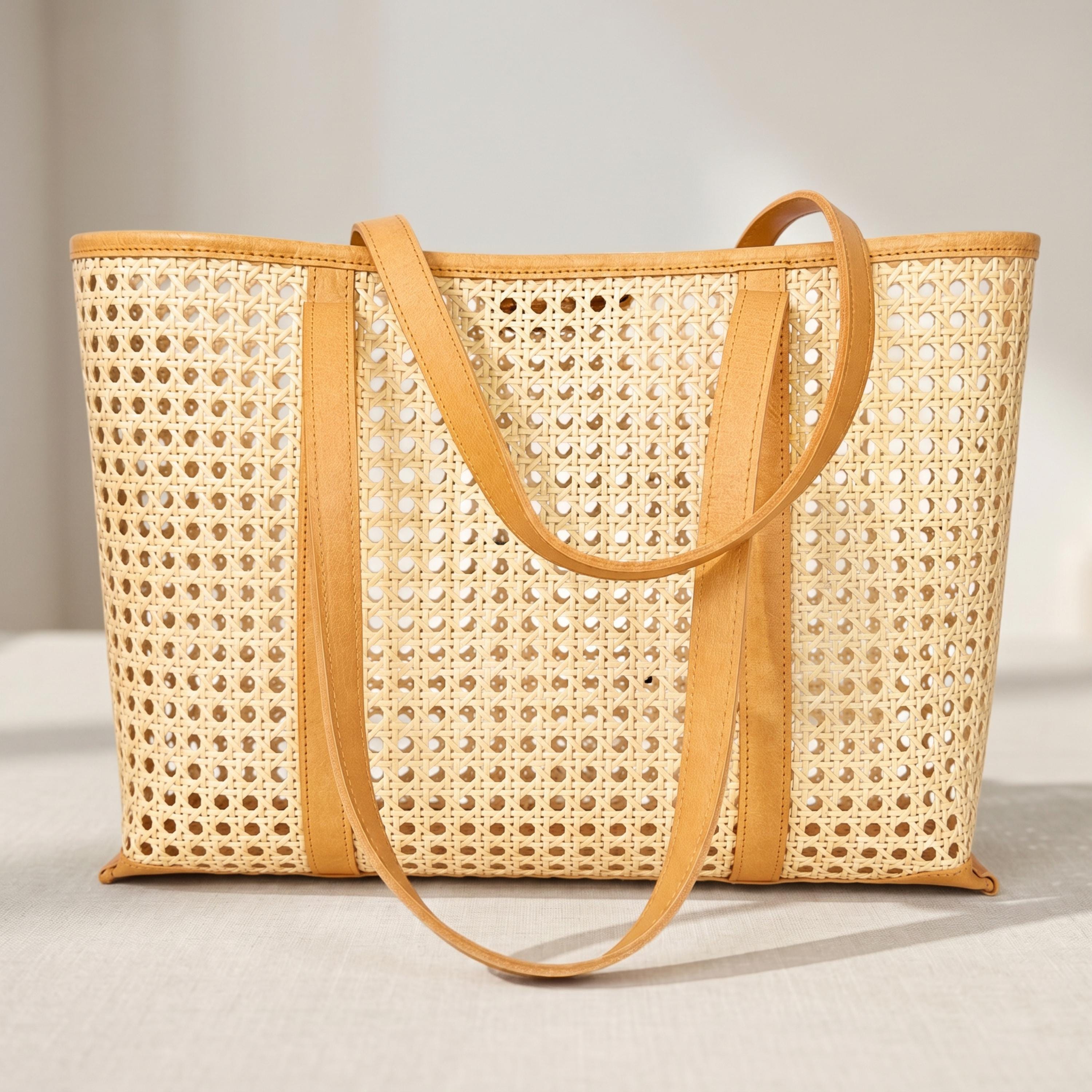 A beige woven tote bag with a distinctive pattern and a leather strap.