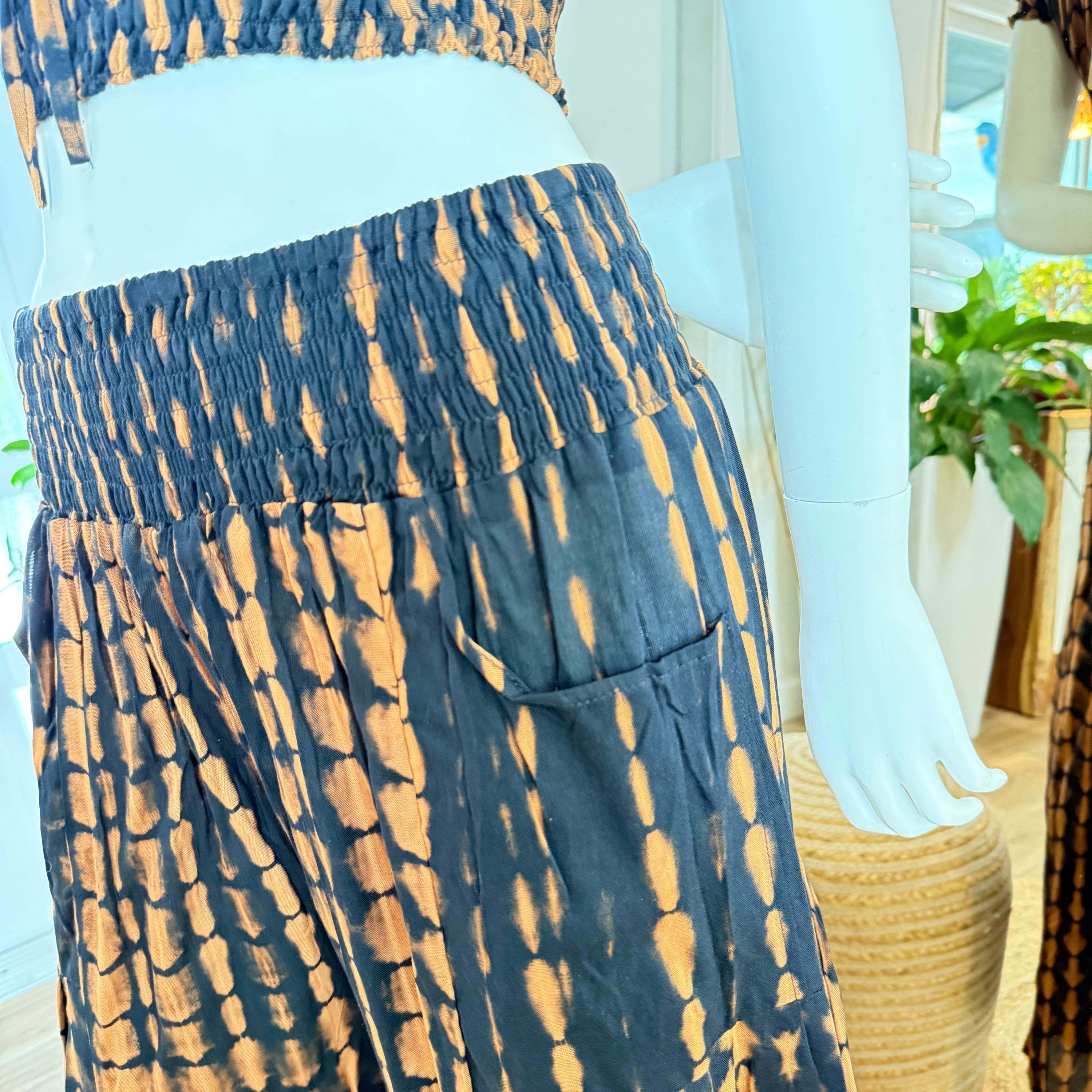 A mannequin wearing a tie-dye skirt with a pattern of blue and orange dots.