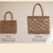 two handbags, one small and one medium, with tags indicating their sizes.