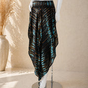 A mannequin wearing a black and blue tie-dye skirt with a high-low hemline.