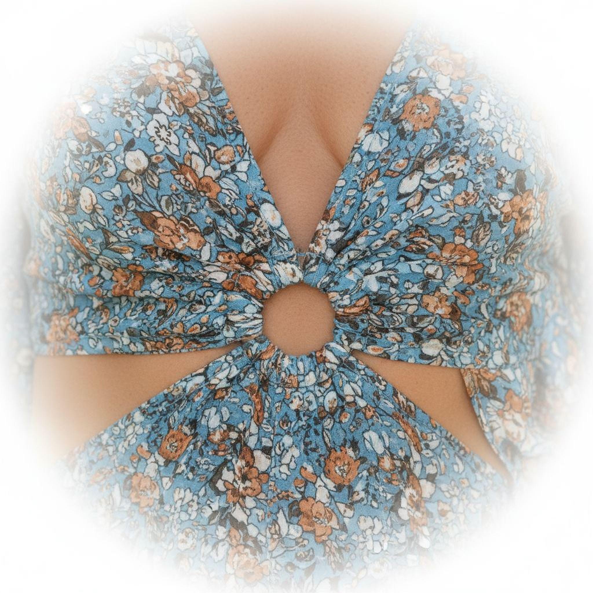 A close-up view of a woman's torso wearing a blue floral print dress with a cutout in the center.