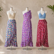 Three mannequins wearing different dresses, each with a unique color and pattern, are displayed in a row.
