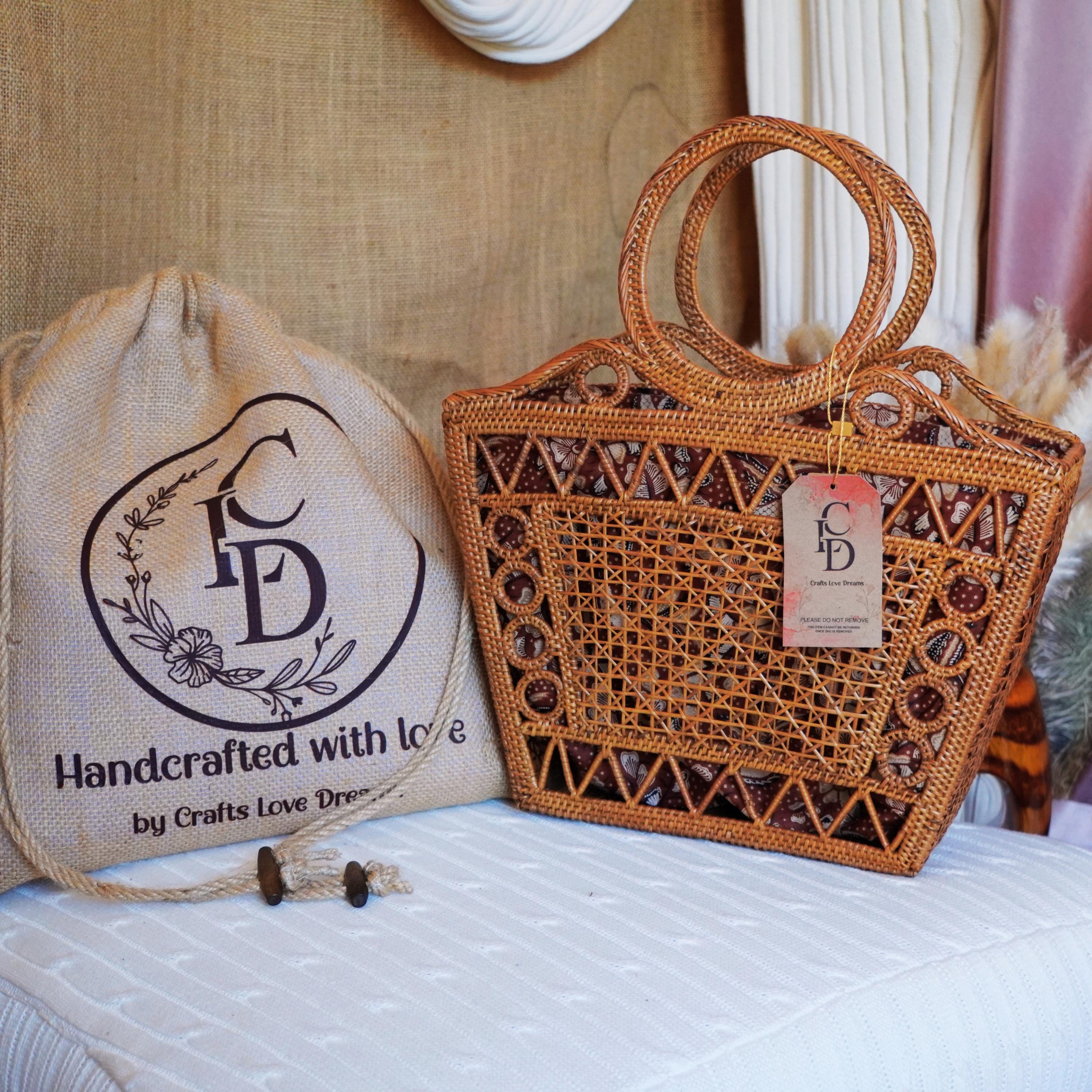 a handcrafted woven bag and a handbag with a tag, both sitting on a white surface.