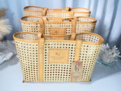 a set of three woven tote bags with a distinctive pattern, placed on a table against a blue background.