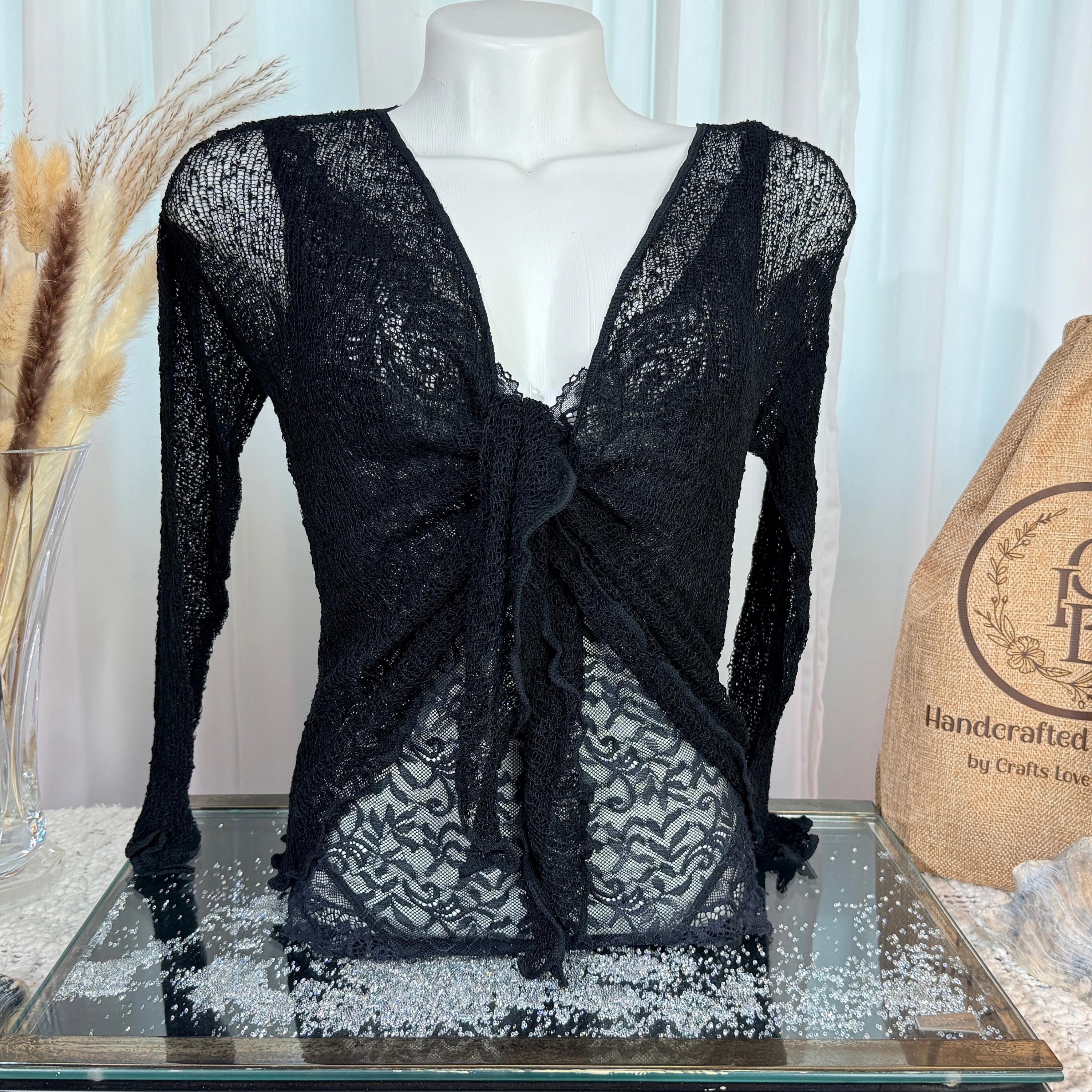 Black sheer knit tie-front cardigan shrug on a mannequin beside a Crafts Love Dreams jute dust bag and dried pampas grass